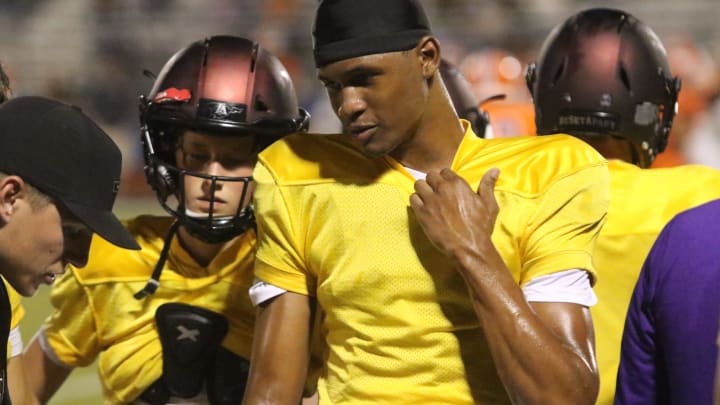 Lipscomb Academy junior quarterback Deuce Knight talks with position coaches on the sideline of their scrimmage against Blackman during the 615 Preseason Showcase Friday, August 11, 2023 at Oakland High School in Murfreesboro, Tennessee.