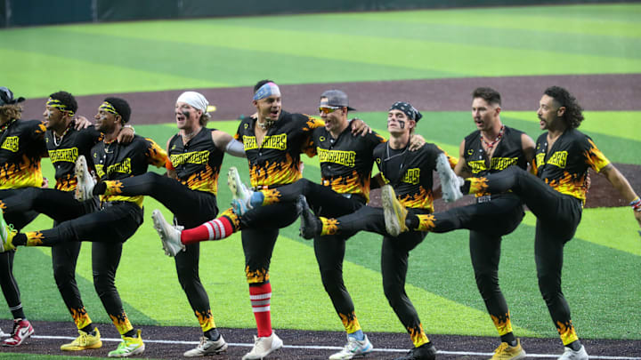 Players from the Firefighters perform a kick line during the first game of the Banana Ball Championship series on Thursday, October 2, 2025 at Historic Grayson Stadium.