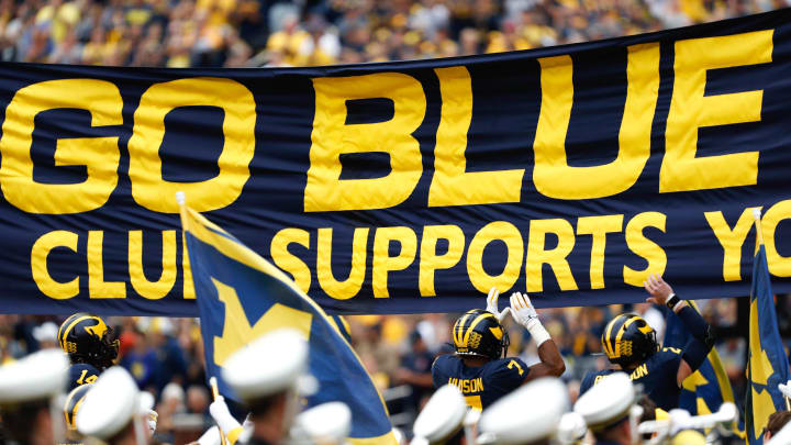 Sep 28, 2019; Ann Arbor, MI, USA; Michigan Wolverines linebacker Khaleke Hudson (7) and quarterback Shea Patterson (2) jump and touch the banner before the game against the Rutgers Scarlet Knights at Michigan Stadium. Mandatory Credit: Raj Mehta-USA TODAY Sports