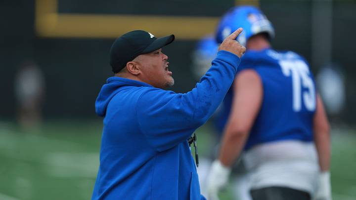 Kansas offensive lineman coach Daryl Agpalsa yells out directions during practice at the outdoor practice fields in Lawrence on July 24, 2025.