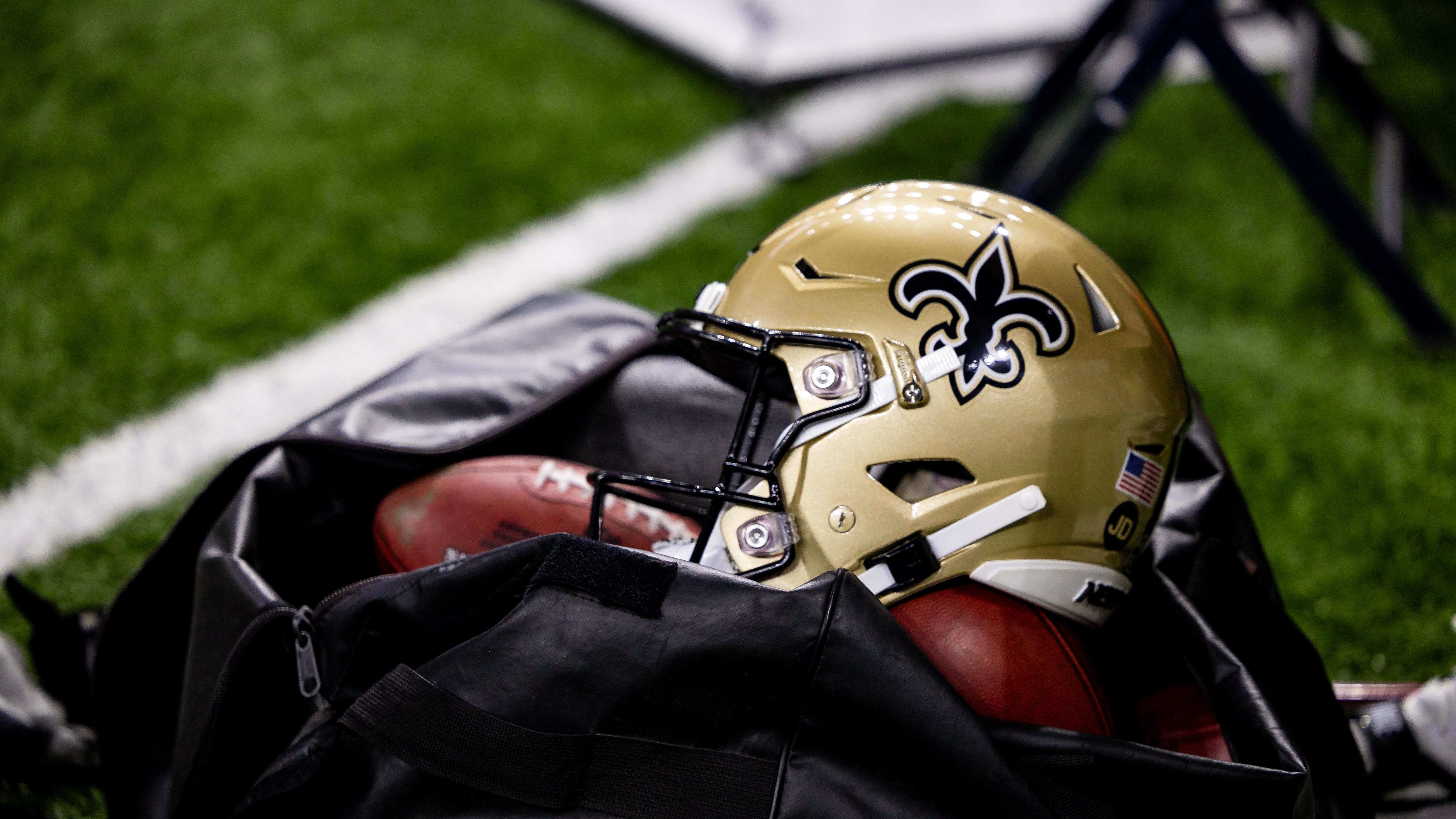 Detailed view of the New Orleans Saints helmet and footballs.
