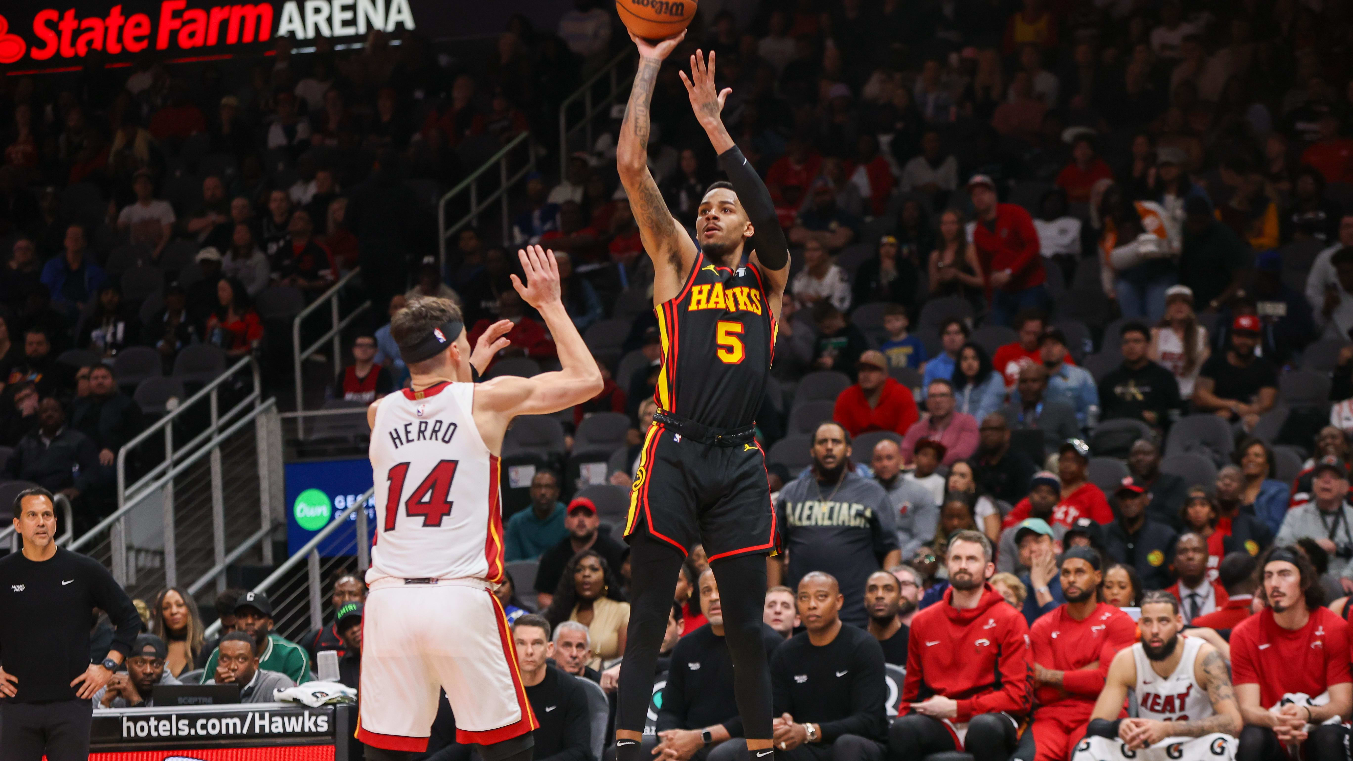 Apr 9, 2024; Atlanta, Georgia, USA; Atlanta Hawks guard Dejounte Murray (5) shoots over Miami Heat