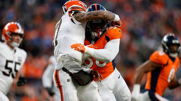 Cleveland Browns quarterback Dorian Thompson-Robinson (17) is hit by Denver Broncos linebacker Baron Browning (56).