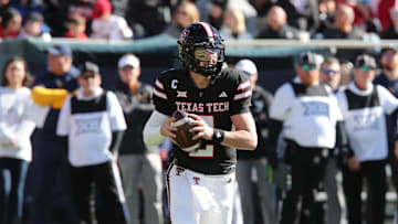 Nov 30, 2024; Lubbock, Texas, USA;  Texas Tech Red Raiders quarterback Behren Morton (2) drops back to pass against the West Virginia Mountaineers in the first half at Jones AT&T Stadium and Cody Campbell Field. Mandatory Credit: Michael C. Johnson-Imagn Images