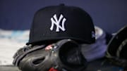 Aug 14, 2023; Atlanta, Georgia, USA; A detailed view of a New York Yankees hat and glove on the bench against the Atlanta Braves in the third inning at Truist Park. Mandatory Credit: Brett Davis-Imagn Images