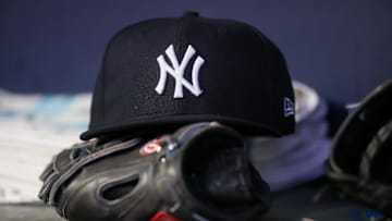 Aug 14, 2023; Atlanta, Georgia, USA; A detailed view of a New York Yankees hat and glove on the bench against the Atlanta Braves in the third inning at Truist Park. Mandatory Credit: Brett Davis-Imagn Images