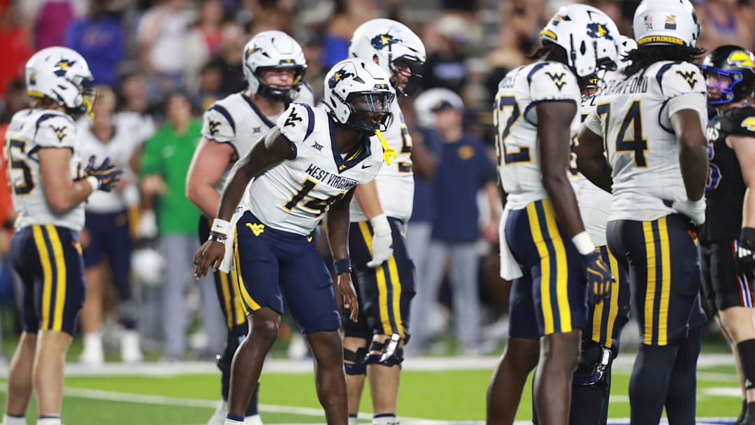 West Virginia Mountaineers quarterback Khalil Wilkins (14) makes calls during the second half of the game against Kansas Jayhawks at David Booth Kansas Memorial Stadium on Sept. 20, 2025.