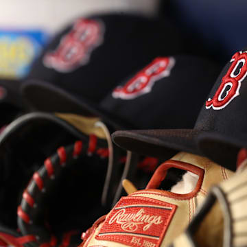 May 22, 2018; St. Petersburg, FL, USA; A general view of Boston Red Sox hats and gloves laying in the dugout at Tropicana Field. Mandatory Credit: Kim Klement-Imagn Images