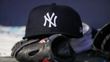 Aug 14, 2023; Atlanta, Georgia, USA; A detailed view of a New York Yankees hat and glove on the bench against the Atlanta Braves in the third inning at Truist Park. Mandatory Credit: Brett Davis-Imagn Images