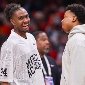 Mar 23, 2025; Atlanta, Georgia, USA; Philadelphia 76ers guard Tyrese Maxey (0) talks to guard Kyle Lowry (7) during a timeout against the Atlanta Hawks in the second quarter at State Farm Arena. Mandatory Credit: Brett Davis-Imagn Images