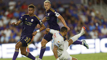 Aug 9, 2024; Orlando, Florida, USA; Cruz Azul forward Giorgos Giakoumakis (11) is tackled by Orlando City defender Robin Jansson (6) and defender Rafael Santos (3) during the first half at INTER&CO Stadium. Mandatory Credit: Morgan Tencza-USA TODAY Sports