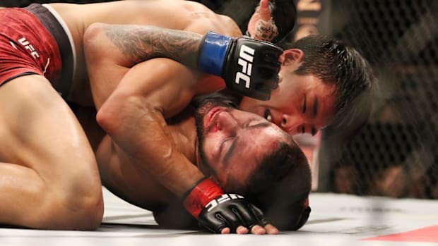 Seungwoo Choi (red gloves) fights Suman Mokhtarian (blue gloves) during UFC Fight Night at Sajik Arena.