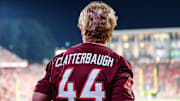 Sep 27, 2025; Raleigh, N.C.; A fan of Virginia Tech linebacker Brett Clatterbaugh (44) fan takes in the game between the Hokies and N.C. State.