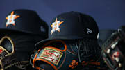 Apr 21, 2023; Atlanta, Georgia, USA; A detailed view of a Houston Astros hat and glove in the dugout against the Atlanta Braves in the fifth inning at Truist Park. 