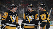 Feb 22, 2025; Pittsburgh, Pennsylvania, USA; Pittsburgh Penguins center Sidney Crosby (87) talks with defenseman Erik Karlsson (65) and left wing Michael Bunting (8) against the Washington Capitals during the first period at PPG Paints Arena. Mandatory Credit: Charles LeClaire-Imagn Images