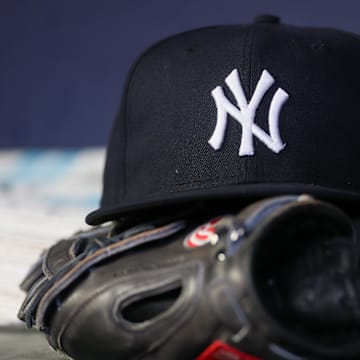 Aug 14, 2023; Atlanta, Georgia, USA; A detailed view of a New York Yankees hat and glove on the bench against the Atlanta Braves in the third inning at Truist Park. Mandatory Credit: Brett Davis-Imagn Images