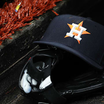 Mar 28, 2019; St. Petersburg, FL, USA; A detail view of a Houston Astros baseball hat and glove lay in the dugout at Tropicana Field. 