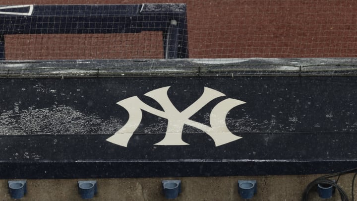 Aug 17, 2020; Bronx, New York, USA; A general view of rain falling on the  New York Yankees logo on the first base dugout roof during a rain delay in the game between the New York Yankees and the Boston Red Sox. Mandatory Credit: Vincent Carchietta-USA TODAY Sports