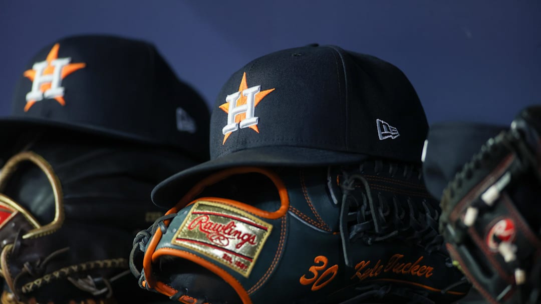 Apr 21, 2023; Atlanta, Georgia, USA; A detailed view of a Houston Astros hat and glove in the dugout against the Atlanta Braves in the fifth inning at Truist Park. Apr 21, 2023; Atlanta, Georgia, USA; A detailed view of a Houston Astros hat and glove in the dugout against the Atlanta Braves in the fifth inning at Truist Park.