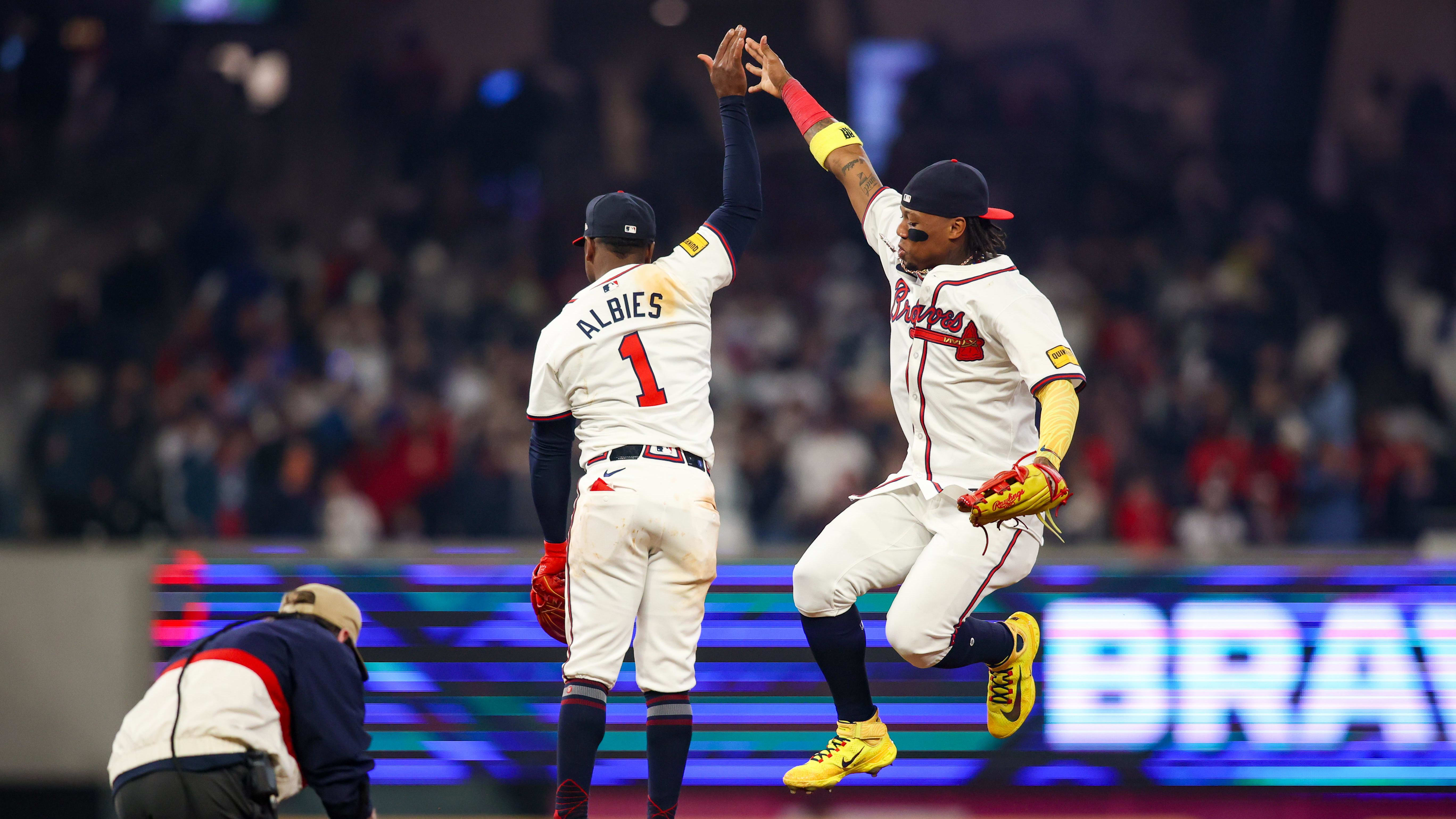 Atlanta Braves second baseman Ozzie Albies and right fielder Ronald Acuña Jr. celebrate the team's come-from-behind victory on Saturday night. 
