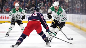 Blue Jackets defenseman Damon Severson battles for the puck against Stars forward Jamie Benn.