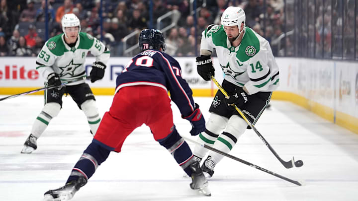 Blue Jackets defenseman Damon Severson battles for the puck against Stars forward Jamie Benn.