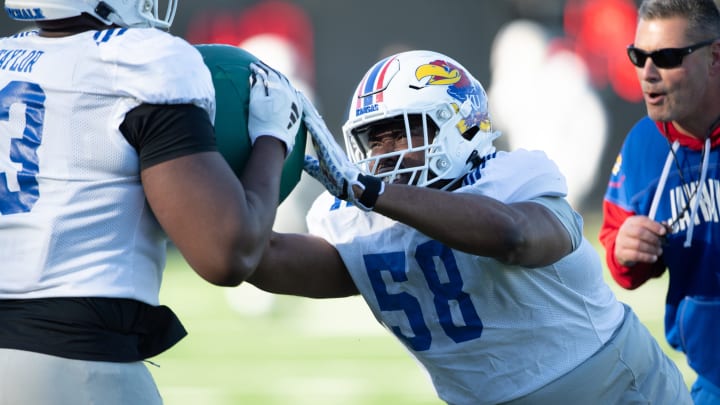 Kansas redshirt senior defensive tackle Javier Derritt (58) works through drills during an outdoor practice Thursday, April 4, 2024.