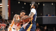 Oct 14, 2023; College Park, Georgia, USA; Atlanta Hawks guard Dejounte Murray (5) and New Orleans Pelicans forward Brandon Ingram (14) fight for the ball during the first quarter at Gateway Center Arena at College Park. 