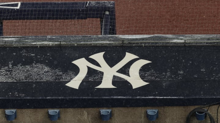 Aug 17, 2020; Bronx, New York, USA; A general view of rain falling on the  New York Yankees logo on the first base dugout roof during a rain delay in the game between the New York Yankees and the Boston Red Sox. Mandatory Credit: Vincent Carchietta-USA TODAY Sports