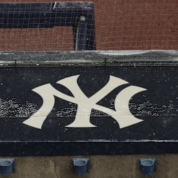 Aug 17, 2020; Bronx, New York, USA; A general view of rain falling on the  New York Yankees logo on the first base dugout roof during a rain delay in the game between the New York Yankees and the Boston Red Sox. Mandatory Credit: Vincent Carchietta-Imagn Images