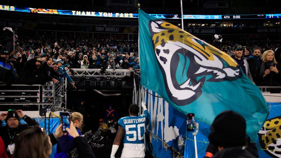 Jacksonville Jaguars linebacker Shaquille Quarterman (50) carries the Jacksonville Jaguars flag into the locker room after the game of an NFL first round playoff football matchup Saturday, Jan. 14, 2023 at TIAA Bank Field in Jacksonville, Fla. The Jacksonville Jaguars edged the Los Angeles Chargers on a field goal 31-30. [Corey Perrine/Florida Times-Union]  | Corey Perrine/Florida Times-Union / USA