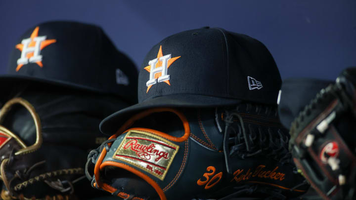 Apr 21, 2023; Atlanta, Georgia, USA; A detailed view of a Houston Astros hat and glove in the dugout against the Atlanta Braves in the fifth inning at Truist Park.