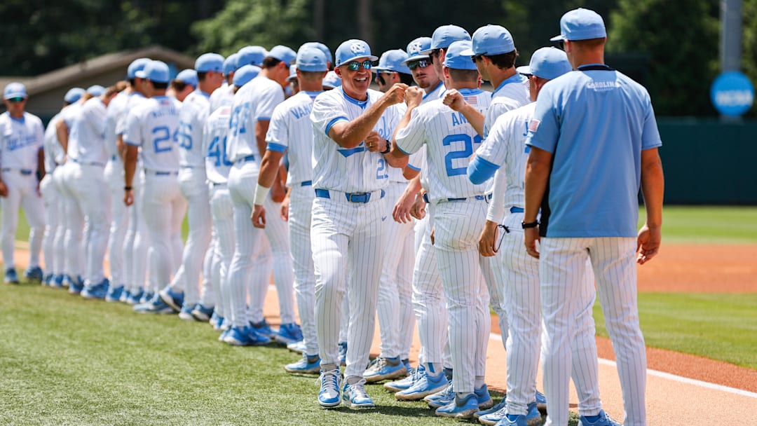 Jun 8, 2025; Chapel Hill, NC, USA;  North Carolina Head Coach Scott Forbes high fives the ream before the first inning of the Super Regionals game against Arizona in Chapel Hill, North Carolina. Mandatory Credit: Jaylynn Nash-Imagn Images