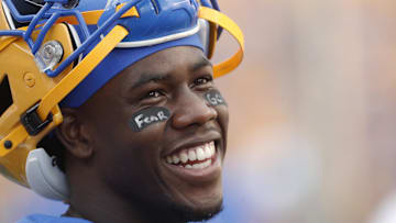 Sep 21, 2024; Pittsburgh, Pennsylvania, USA;  Pittsburgh Panthers wide receiver Konata Mumpfield (9) smiles on the sidelines during the third quarter against the Youngstown State Penguins at Acrisure Stadium. Mandatory Credit: Charles LeClaire-Imagn Images