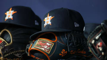 Apr 21, 2023; Atlanta, Georgia, USA; A detailed view of a Houston Astros hat and glove in the dugout against the Atlanta Braves in the fifth inning at Truist Park