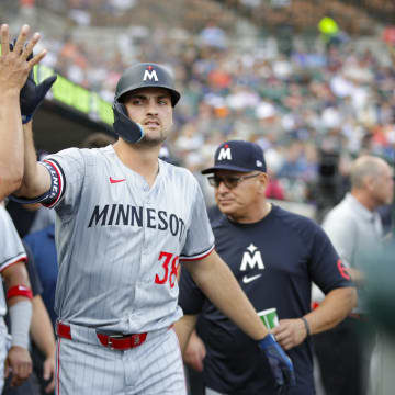 Jul 26, 2024; Detroit, Michigan, USA; Minnesota Twins outfielder Matt Wallner (38) high-fives teammates after scoring a run in the second inning against the Detroit Tigers at Comerica Park.