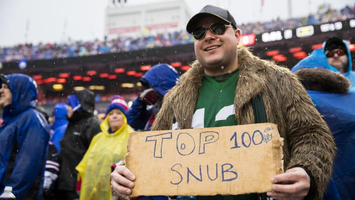 A fan holds a sign reading "Top 100 Snub" at a New York Jets game against Buffalo. 