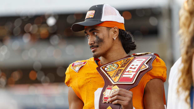 Tennessee Volunteers quarterback Nico Iamaleava poses with the MVP Trophy after defeating the Iowa Hawkeyes.