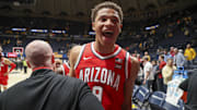 Arizona Wildcats forward Carter Bryant (9) celebrates with coaches after defeating the West Virginia Mountaineers at WVU Coliseum.