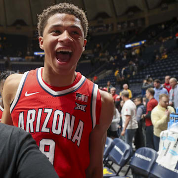 Arizona Wildcats forward Carter Bryant (9) celebrates with coaches after defeating the West Virginia Mountaineers at WVU Coliseum.