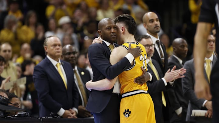 Missouri Tigers head coach Dennis Gates hugs forward Caleb Grill (31) after suffering an unfortunate loss, in a game against the Kentucky Wildcats this season.