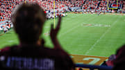 Sep 27, 2025; Raleigh, N.C.; A fan of Virginia Tech linebacker Brett Clatterbaugh (44) fan takes in the game during the second half.