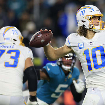 Los Angeles Chargers quarterback Justin Herbert (10) looks to pass during the third quarter of an NFL first round playoff football matchup Saturday, Jan. 14, 2023 at TIAA Bank Field in Jacksonville, Fla. Jacksonville Jaguars edged the Los Angeles Chargers on a field goal 31-30. [Corey Perrine/Florida Times-Union]