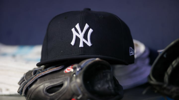 Aug 14, 2023; Atlanta, Georgia, USA; A detailed view of a New York Yankees hat and glove on the bench against the Atlanta Braves in the third inning at Truist Park. Mandatory Credit: Brett Davis-USA TODAY Sports