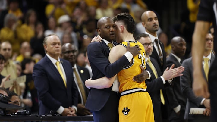 Mar 8, 2025; Columbia, Missouri, USA; Missouri Tigers guard Caleb Grill (31) hugs Missouri Head coach Dennis Gates in the last minutes of the second half against the Kentucky Wildcats at Mizzou Arena. Mandatory Credit: Gary Rohman-Imagn Images