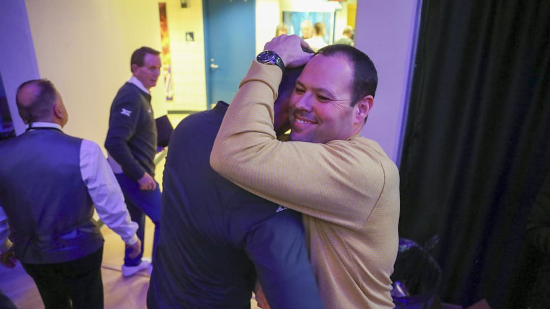 Jan 13, 2024; Morgantown, West Virginia, USA; West Virginia Mountaineers head coach Josh Eilert celebrates with West Virginia Mountaineers Athletic Director Wren Baker after defeating the Texas Longhorns at WVU Coliseum. Mandatory Credit: Ben Queen-Imagn Images