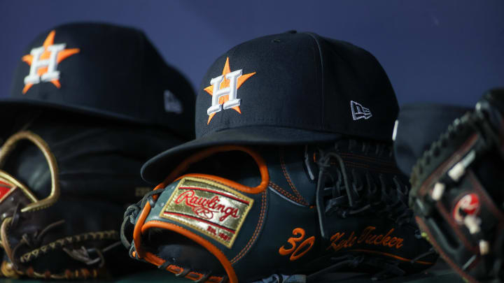 Apr 21, 2023; Atlanta, Georgia, USA; A detailed view of a Houston Astros hat and glove in the dugout against the Atlanta Braves in the fifth inning at Truist Park.