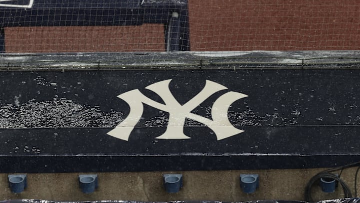 Aug 17, 2020; Bronx, New York, USA; A general view of rain falling on the  New York Yankees logo on the first base dugout roof during a rain delay in the game between the New York Yankees and the Boston Red Sox. Mandatory Credit: Vincent Carchietta-Imagn Images