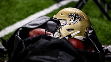 Detailed view of a New Orleans Saints helmet and ball bag