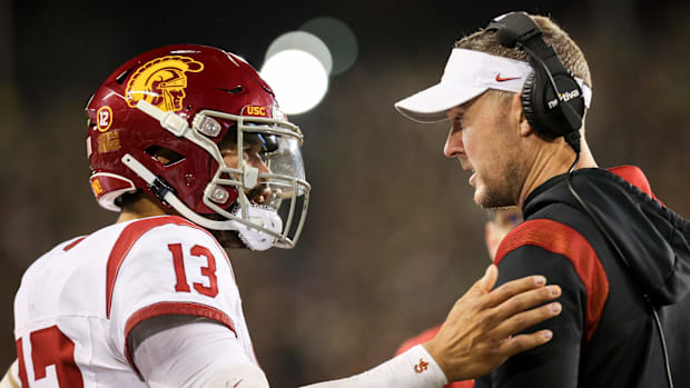 USC Trojans quarterback Caleb Williams talks with USC Trojans head coach Lincoln Riley during the first half of the game agai